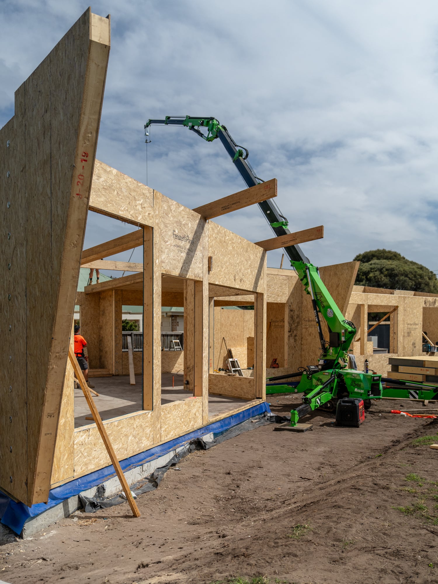 Residential construction with prefabricated panels and crane